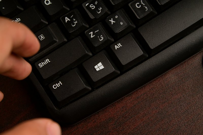 Close up of fingers on a keyboard tab key