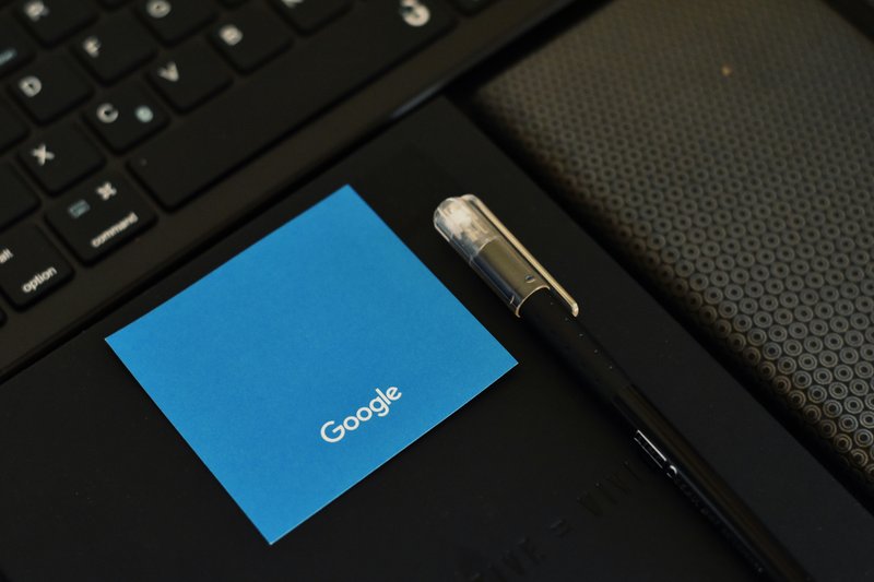 Laptop showing Google search results with red pen markup annotations